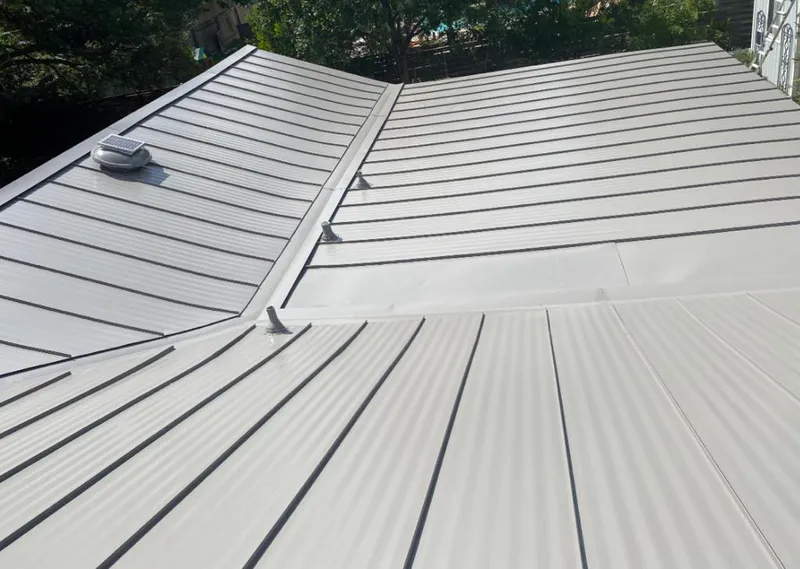 Solar attic fan installed on a metal roof for Roof Ventilation in Waco